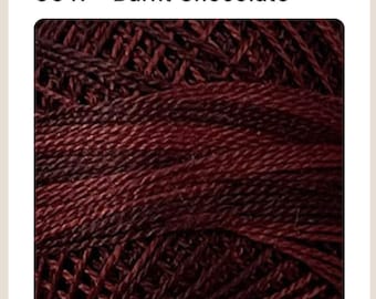 May include: A close-up of a ball of dark red yarn with a subtle gradient of color. The yarn is made of a soft, textured material and is perfect for knitting or crocheting.