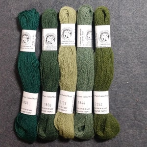 May include: Five skeins of green wool yarn, labeled with the brand name "Fine Dale" and the numbers 1826, 1836, 2133, 1844, and 2952. The yarn is labeled as "Pure Laine/Wool" and "Colour Fast Grand Teint".