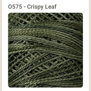 May include: Close-up of a skein of green yarn with a textured, woven look. The yarn is labeled "0575 - Crispy Leaf".