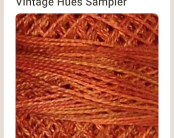 May include: Close-up of a skein of rusty orange yarn. The yarn is a blend of fibers and has a subtle sheen. P6 - Rusted Orange - Vintage Hues Sampler.
