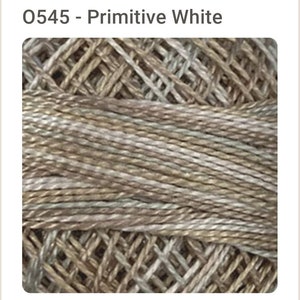 May include: Close-up of a skein of embroidery floss in a variegated colorway of white, beige, and brown. The floss is woven in a criss-cross pattern.
