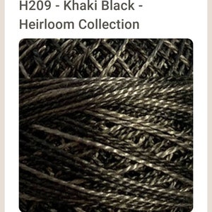 May include: Close-up of a skein of black and khaki embroidery floss. The floss is twisted and has a subtle sheen. The floss is labeled "H209 - Khaki Black - Heirloom Collection".