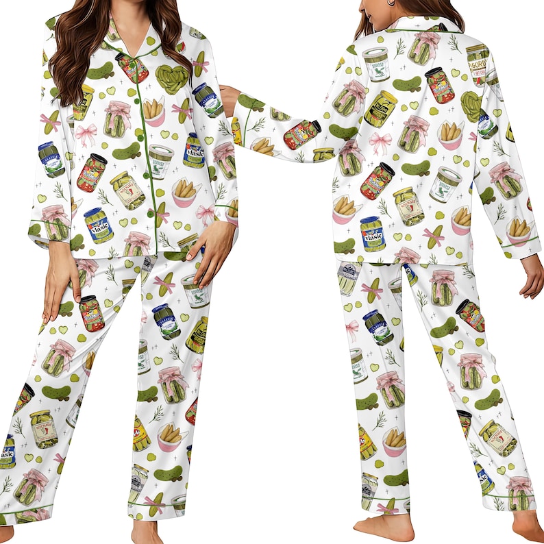 May include: White pajama set with a repeating pattern of pickle jars, pickles, and pink bows. The long-sleeved top and pants have green trim. The pajama set is made of a soft, comfortable material.
