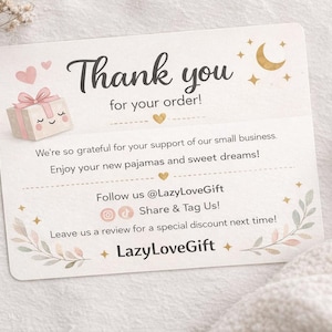 May include: A thank you card with the text "Thank you for your order!" and a gift box illustration. The card includes the text "Enjoy your new pajamas and sweet dreams!" and social media handles.