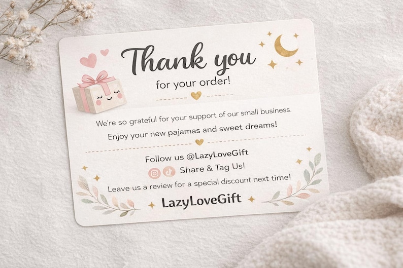 May include: A thank you card with the text "Thank you for your order!" and a gift box illustration. The card includes the text "Enjoy your new pajamas and sweet dreams!" and social media handles.