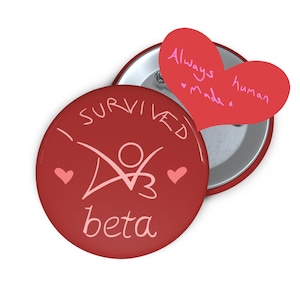 May include: A red button with the text "I SURVIVED beta" and a stylized figure. A red heart-shaped paper with the words "Always made human" is next to the button. Two small pink hearts are on the button.