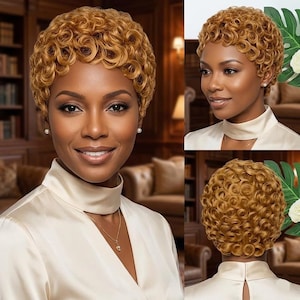 May include: A woman with short, curly, golden-brown hair. She is wearing a cream-colored satin top and pearl earrings. The background includes a bookshelf and a glimpse of a room with warm lighting.