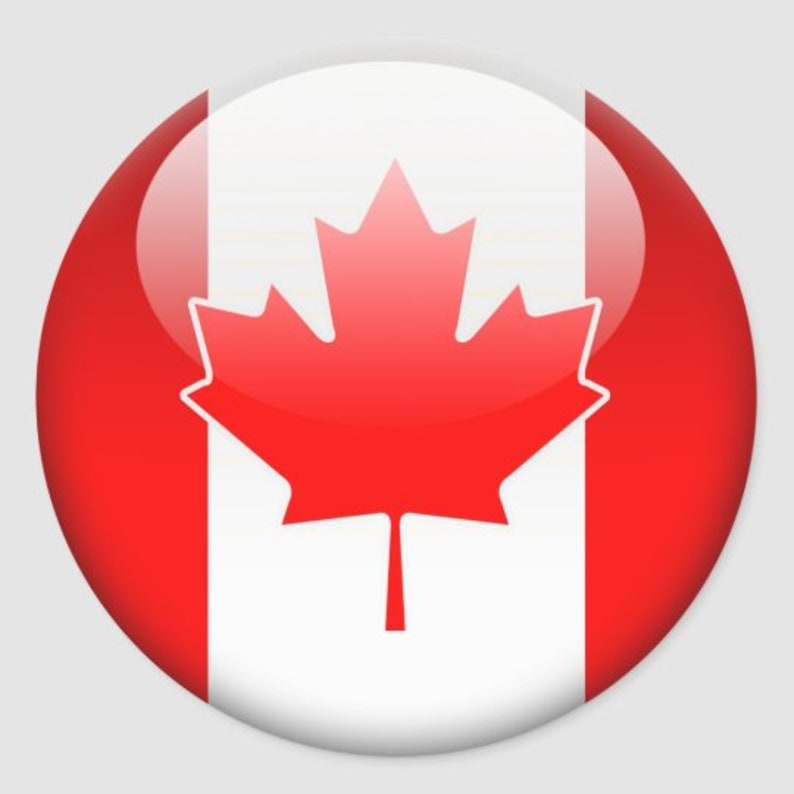 Op de afbeelding: Een ronde knop met een glanzende afwerking toont de Canadese vlag. De vlag is rood en wit met een groot rood esdoornblad in het midden.