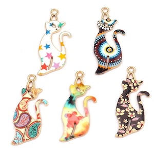 May include: Six gold-tone metal cat charms with different colorful enamel patterns. The charms are perfect for jewelry making, scrapbooking, and other craft projects.