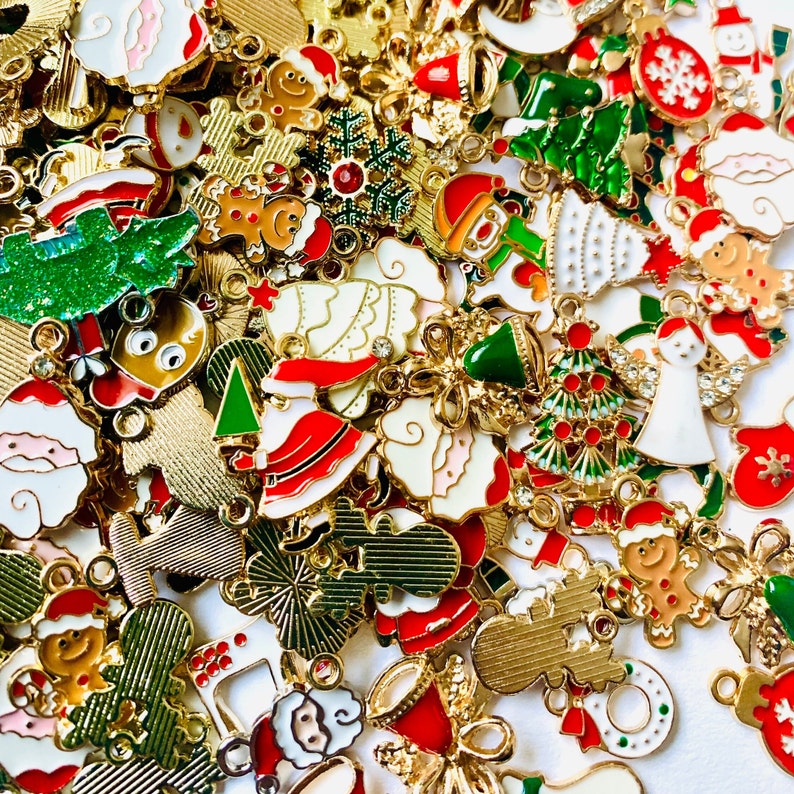 May include: Assortment of gold-tone Christmas charms with various designs, including snowflakes, reindeer, Santa Claus, and Christmas trees. The charms are perfect for adding a festive touch to jewelry, crafts, and other projects.