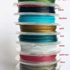 May include: A stack of spools of wire in various colors, including brown, spring green, black, sky blue, gold, teal, white, pink rose, silver, and brick red. The spools are labeled with the color of the wire.