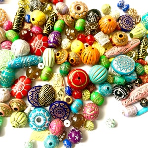 May include: A large assortment of colorful, patterned, and textured beads. The beads are made of various materials, including wood, glass, and plastic. They are perfect for jewelry making, crafting, and home decor.