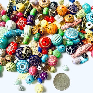 May include: A large assortment of colorful, patterned, and textured beads. The beads are made of wood, glass, and plastic. They are perfect for jewelry making, crafts, and home decor.
