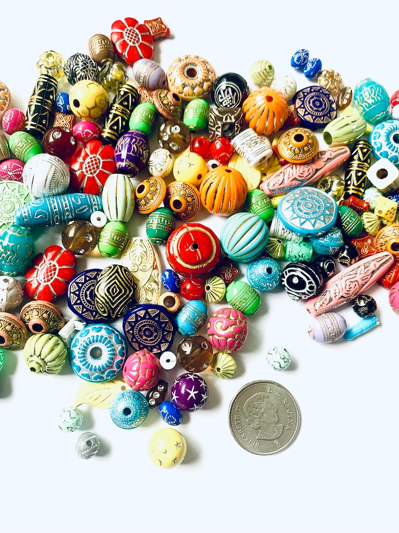 May include: A large assortment of colorful, patterned, and textured beads. The beads are made of wood, glass, and plastic. They are perfect for jewelry making, crafts, and home decor.