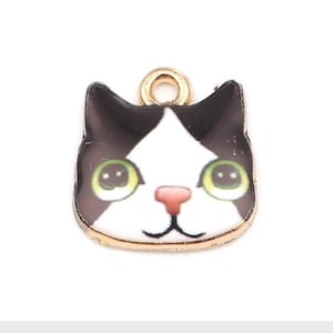black cat face charm, enamel cat  with smiling face, green eye black and white cat , gold plated back
