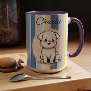 May include: White ceramic mug with a purple handle and interior. The mug features a cartoon puppy illustration with the name "Charlie" in script. The mug has vertical stripes in blue, yellow, and white.