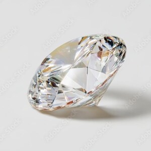 May include: A clear, faceted gemstone with a brilliant cut, displaying multiple triangular and kite-shaped surfaces that reflect light. The stone is transparent and colorless, featuring sharp edges and a pointed base, showcasing high clarity and precision.