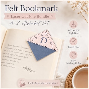 May include: A corner felt bookmark featuring a light pink top layer with a scalloped edge and the letter D, layered over a solid dark blue base. The text reads Felt Bookmark Laser Cut File Bundle A-Z Alphabet Set, SVG, DXF, LightBurn, Tested Files, Easy Stitching Holes, and Hello Moonberry Studio.