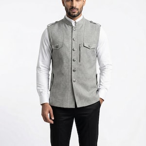 May include: A white ceramic mug with a black handle and the text "But First, Coffee" in a black, bold font. The mug is sitting on a wooden surface. The mug is approximately 4 inches tall.