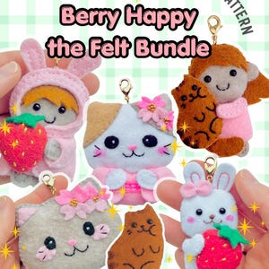 May include: A PDF sewing pattern titled Berry Happy the Felt Bundle featuring felt plush charms including a person in a pink bunny hood with a strawberry, a cat with pink flowers, a person with a brown cat, a cat face, a brown cat, and a white bunny.