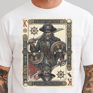 May include: White t-shirt featuring a playing card design with a pirate theme. The card depicts a pirate captain holding a sword and shield, with the text "Dread Captain" and the letter "K".