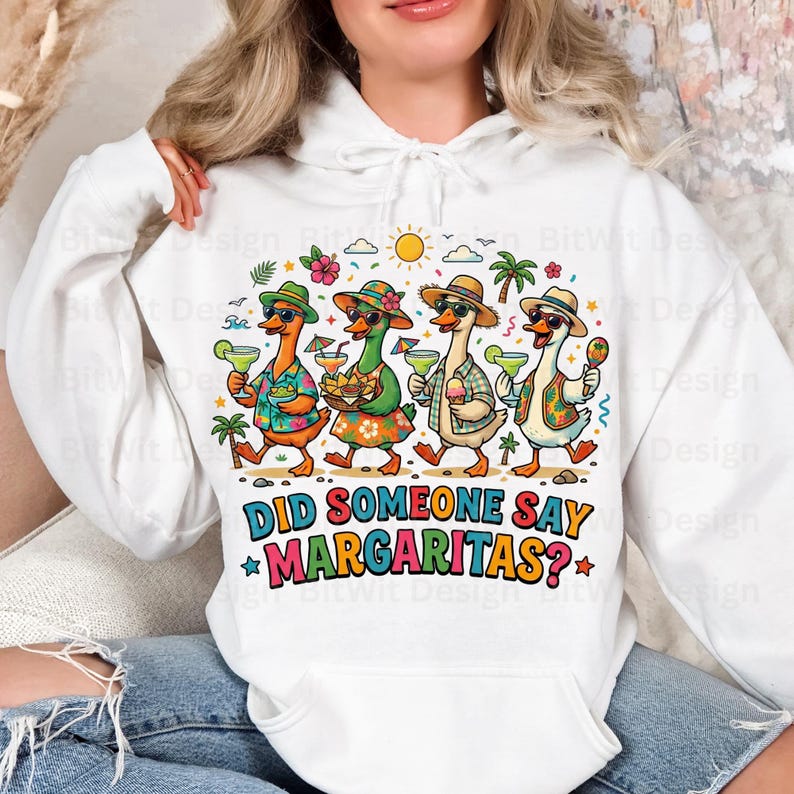 May include: A white hooded sweatshirt featuring a colorful graphic of four cartoon ducks wearing tropical hats and sunglasses, holding margaritas and snacks. The text below the ducks reads, "DID SOMEONE SAY MARGARITAS?" in bold, multi-colored letters.