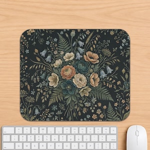 May include: A rectangular mouse pad featuring a dark black background with a detailed botanical illustration of a floral bouquet. The arrangement includes various flowers in shades of peach, cream, and blue, interspersed with green fern leaves.