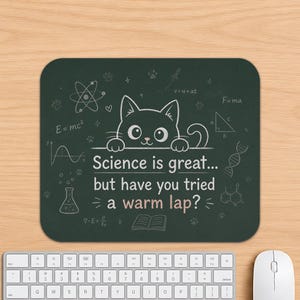 May include: A rectangular dark green mouse pad featuring a white line drawing of a cat peeking over a line. The text reads: Science is great... but have you tried a warm lap? Scientific symbols like an atom, DNA, and formulas are printed in white.