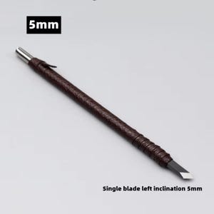 May include: A brown-handled carving tool with a silver tip and a single blade. The text "5mm" is in a black box at the top, and "Single blade left inclination 5mm" is at the bottom.