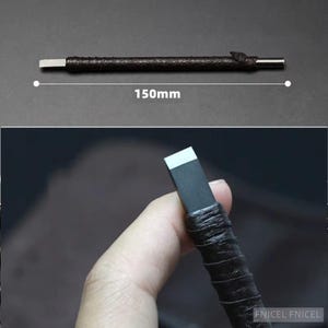 May include: A dark brown leather-wrapped tool with a silver metal blade and end. The tool is approximately 150mm long. The image shows the tool against a dark background, with a close-up of the tool being held.