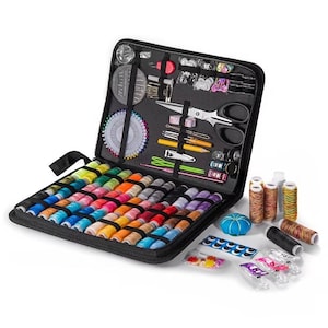 May include: Open black sewing kit filled with colourful thread spools, needles, scissors, and other sewing notions. Includes a pin cushion, buttons, and bobbins. The kit is designed for sewing and crafting projects.