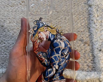 May include: A clear phone case featuring a printed illustration of a blonde character wearing a blue patterned outfit with the word DIO on their hat. The character has small creatures on their shoulder and hand, rendered in a detailed comic style.