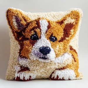 May include: A square decorative pillow featuring a detailed, textured image of a Corgi dog. The pillow has a cream-colored background with the dog's face in shades of brown, white, and black. The dog's ears are upright, and its eyes are dark.