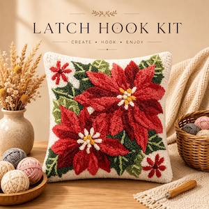 May include: A square latch hook kit pillow featuring a cream background with a vibrant red poinsettia floral design and green leaves. The text LATCH HOOK KIT CREATE HOOK ENJOY is printed above the pillow. The design includes yellow and white centers.