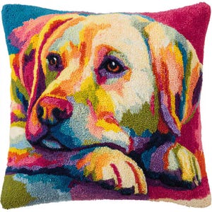 May include: A square decorative pillow featuring a colorful, abstract portrait of a Labrador Retriever. The dog's face is rendered in a vibrant palette of yellow, orange, pink, blue, and green, with a magenta background.