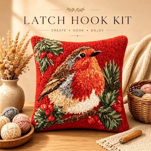 May include: A square latch hook kit pillow featuring a red background with a central robin bird perched on a branch, surrounded by green pine needles and red berries. The text LATCH HOOK KIT CREATE HOOK ENJOY is printed above the pillow.