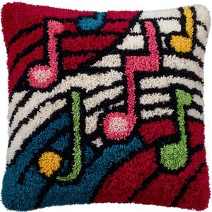 May include: Square decorative cushion with a colourful musical note design. The cushion features a red background with black stripes, white and black zebra stripes, and musical notes in pink, green, and yellow. The cushion is approximately 40 cm square.