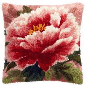 May include: Square decorative pillow with a large, detailed floral design. The pillow features a vibrant red and pink peony with white accents and yellow center. Green leaves and a pink background complete the design.