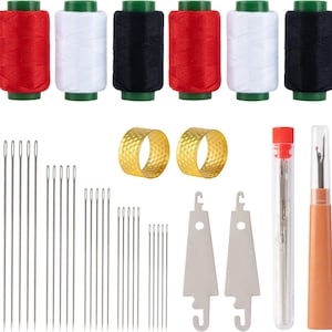 May include: A sewing kit with spools of red, white, and black thread, thimbles, needles, and a seam ripper. The thread spools have green bases. The needles are various sizes. The thimbles are gold-colored. The seam ripper has an orange handle.