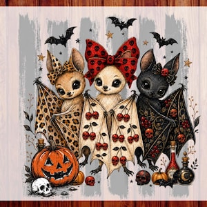 May include: A DTF transfer print featuring three cartoon bats with large eyes. The left bat has leopard print wings, the center bat wears a red skull-patterned bow, and the right bat has black wings with red skulls. Includes pumpkins, skulls, and text.