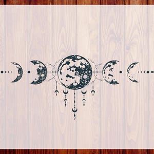 May include: A black and white moon phases design with a central large moon and smaller crescent moons on either side. The design includes dotted lines and hanging decorative elements. The text "CUSTOM DTF" and "READY TO PRESS" are on the sides.
