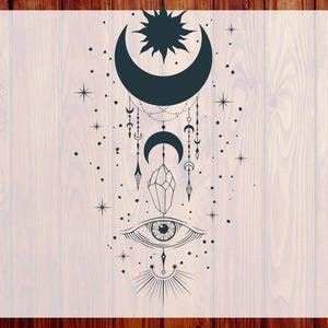 May include: A celestial-themed design featuring a crescent moon, sun, stars, and an eye. The design includes a crystal and dangling charms. The words "CUSTOM DTF" and "READY TO PRESS" are printed on the sides.