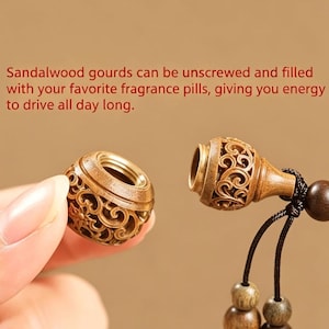May include: A carved sandalwood gourd pendant that unscrews into two pieces. The text reads: Sandalwood gourds can be unscrewed and filled with your favorite fragrance pills, giving you energy to drive all day long. It features intricate openwork.