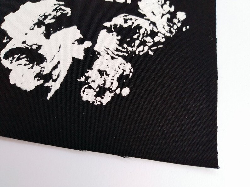 May include: Black fabric patch with a white design of abstract shapes.