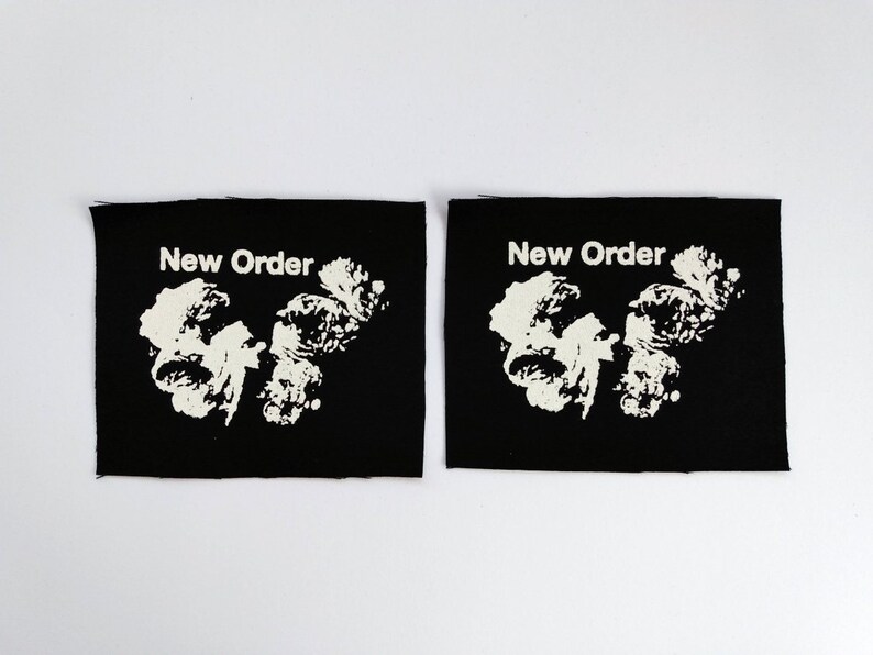 May include: Two black fabric patches with white text and a white graphic. The text on both patches reads "New Order".