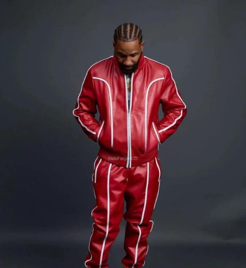 May include: A red leather tracksuit with white piping. The jacket has a zip closure and pockets. The trousers have a straight leg design. The text "HideForgCO" is visible on the jacket.