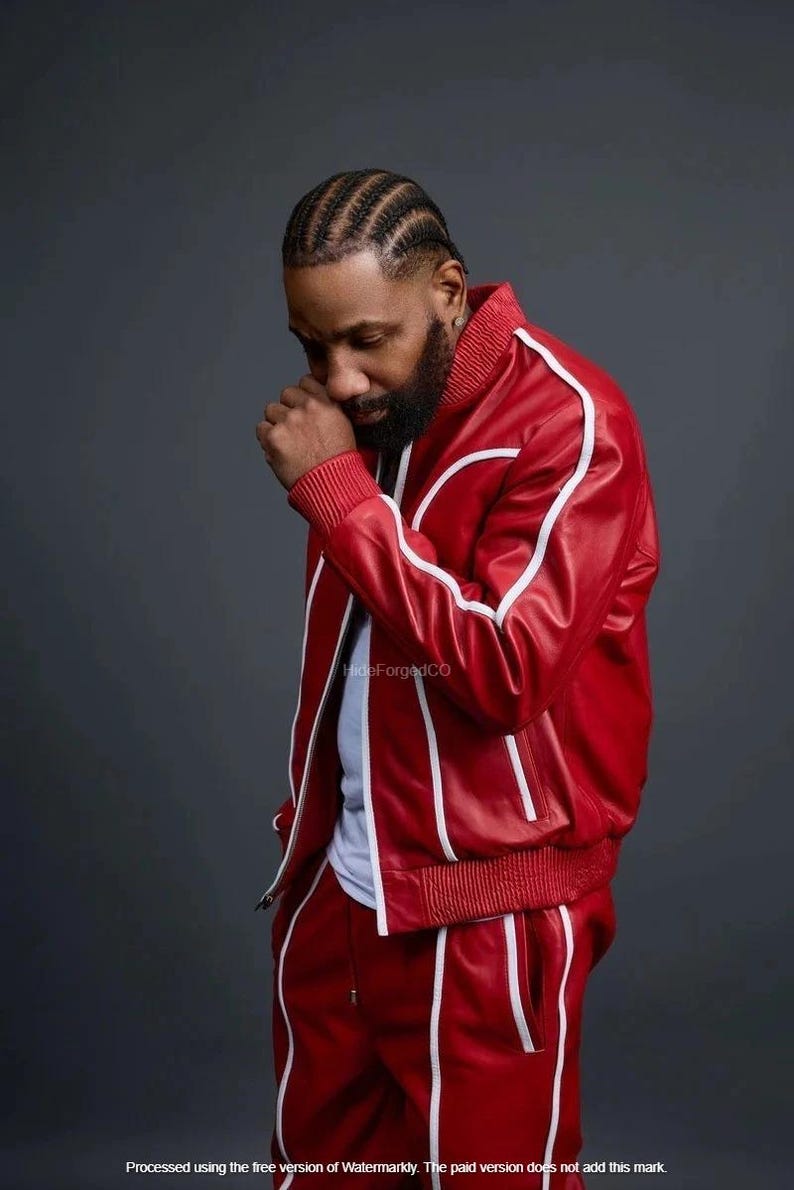 May include: Red leather tracksuit with white stripes. The jacket has a bomber style with a ribbed collar and cuffs. The trousers have a drawstring waist. The image includes the text "HideForgedCO".