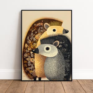 May include: A framed vertical art print featuring two stylized hedgehogs. The larger hedgehog is golden-yellow with brown floral patterns on its back, while the smaller one is grey with black speckles. Both have dark noses and large eyes.