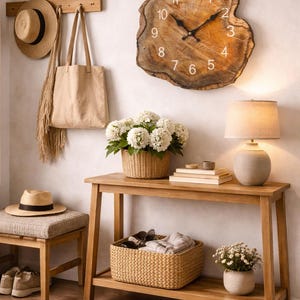 May include: A rustic interior scene featuring a wooden console table with a woven basket, lamp, and floral arrangement. A large, round wooden clock hangs on the wall. Accessories include hats, a tote bag, and a bench with a hat.