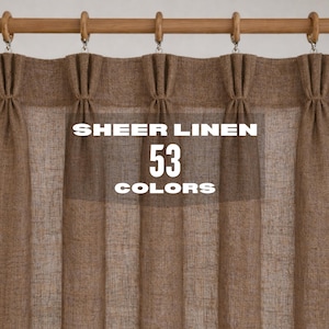May include: A brown sheer linen curtain with a pleated top header hanging from a wooden rod with matching rings. The fabric has a visible woven texture. Centered text on the curtain reads: SHEER LINEN 53 COLORS in white capital letters.